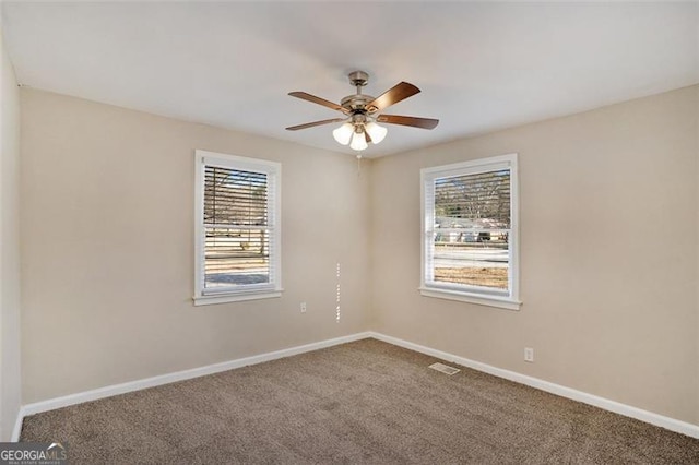 unfurnished room featuring ceiling fan, plenty of natural light, and carpet flooring