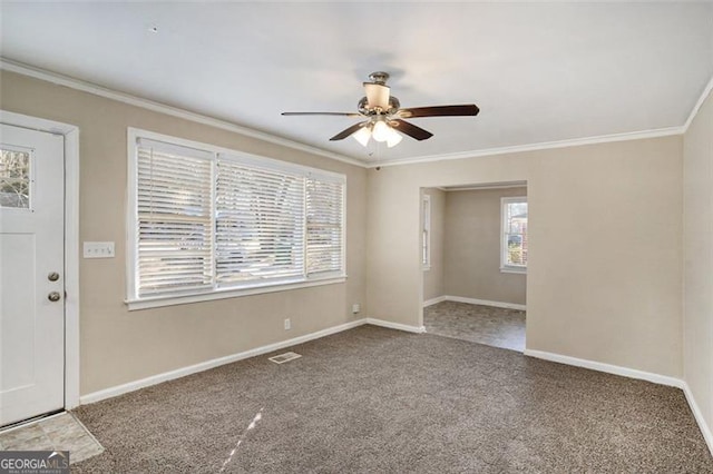 interior space with ceiling fan, crown molding, and carpet