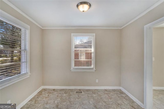 spare room featuring crown molding