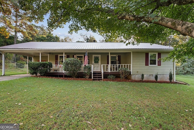 view of front of property with a carport, a front yard, and covered porch