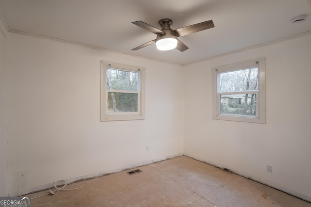 spare room featuring ceiling fan and crown molding