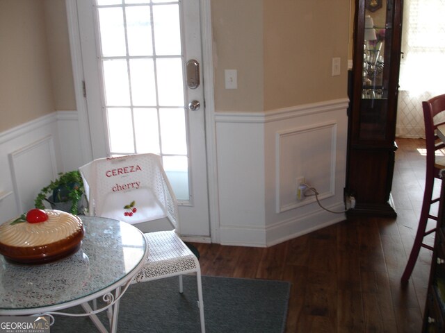 entryway with wainscoting, wood finished floors, and a decorative wall