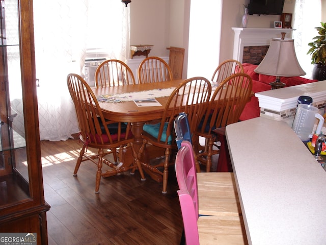 dining room featuring a fireplace and wood-type flooring