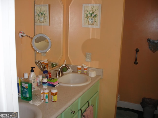 bathroom featuring toilet and vanity