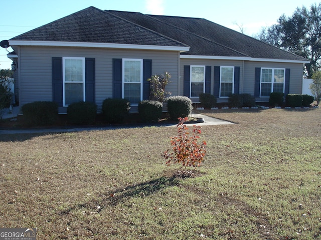 ranch-style home with a front lawn