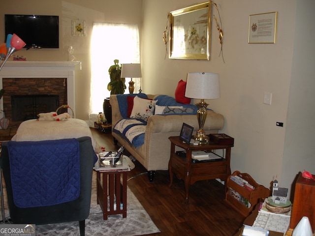 living room with dark wood-type flooring and a fireplace