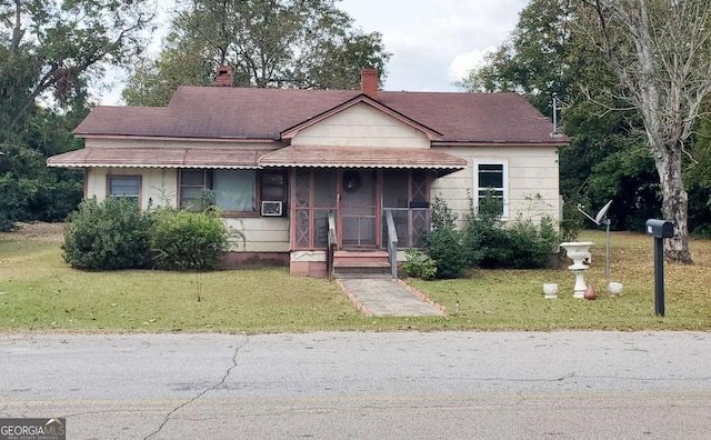 bungalow-style home featuring a front lawn