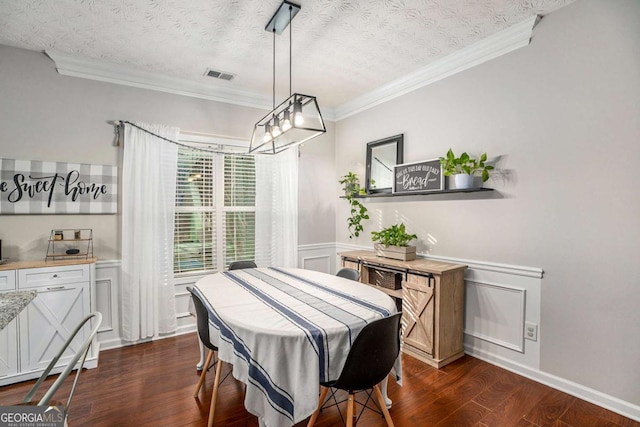 dining space with ornamental molding, dark hardwood / wood-style floors, and a textured ceiling