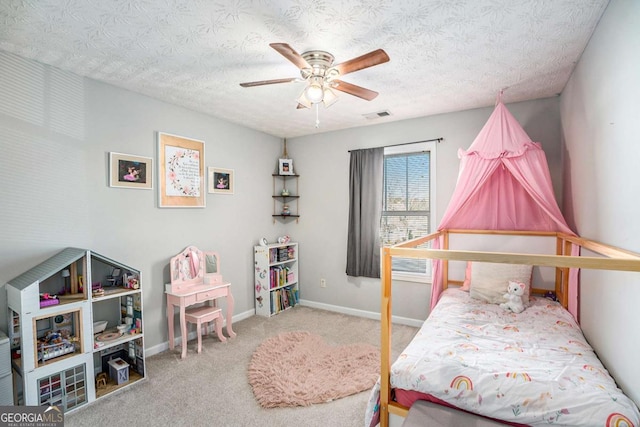 bedroom featuring ceiling fan, carpet, and a textured ceiling