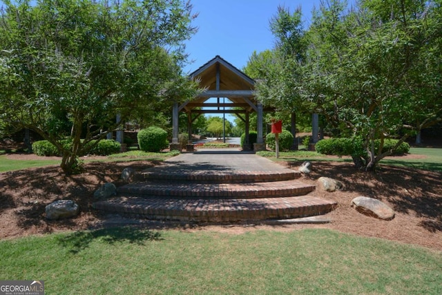 view of property's community with a gazebo and a yard