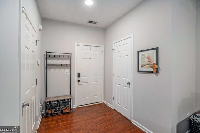 entryway with dark hardwood / wood-style flooring