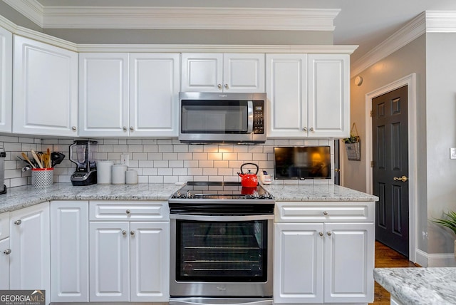 1231 Scarlet Oak Cir, Athens, GA 30606 - kitchen with stainless steel appliances, white cabinets, crown molding, decorative backsplash, and wood finished floors