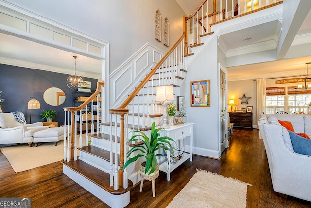 1231 Scarlet Oak Cir, Athens, GA 30606 - stairway featuring a chandelier, crown molding, wood finished floors, a towering ceiling, and baseboards