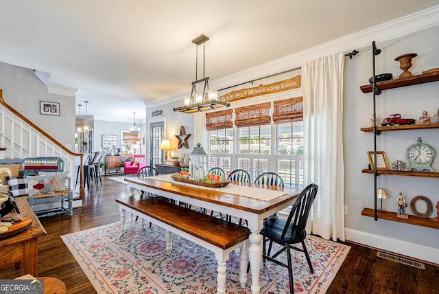 1231 Scarlet Oak Cir, Athens, GA 30606 - dining area featuring a chandelier, ornamental molding, stairway, dark wood finished floors, and baseboards