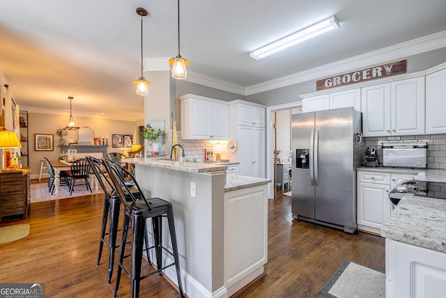 1231 Scarlet Oak Cir, Athens, GA 30606 - kitchen featuring stainless steel refrigerator with ice dispenser, ornamental molding, a peninsula, backsplash, and white cabinets