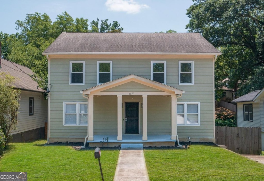 view of front facade featuring covered porch and a front yard