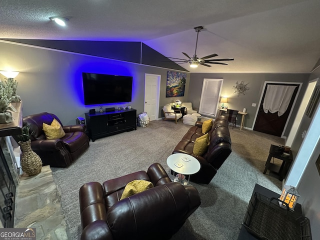 carpeted cinema room featuring a textured ceiling, ceiling fan, and vaulted ceiling