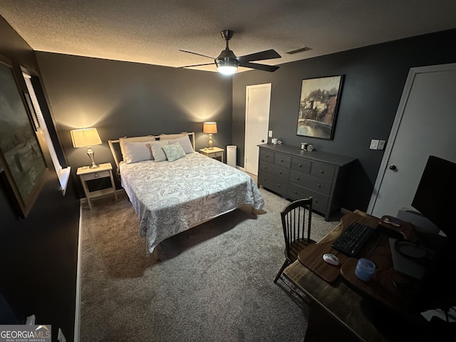 carpeted bedroom featuring a textured ceiling and ceiling fan