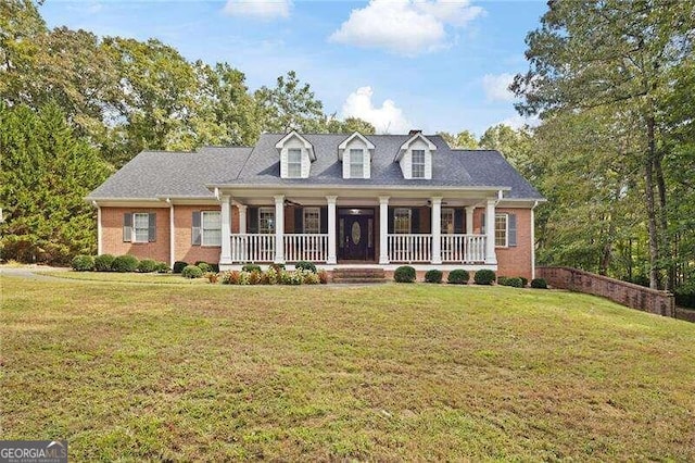 cape cod house with a porch and a front yard