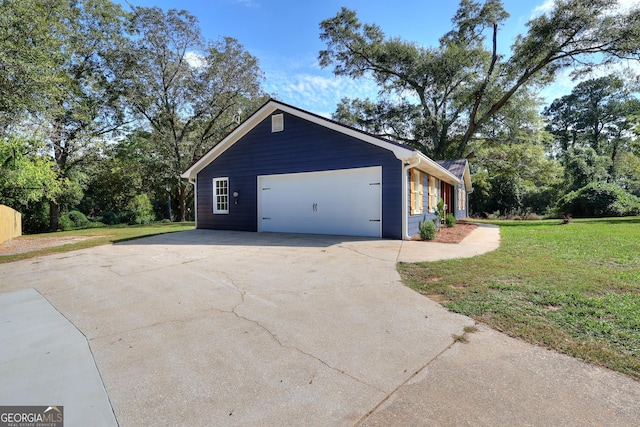 view of side of home featuring a yard and a garage