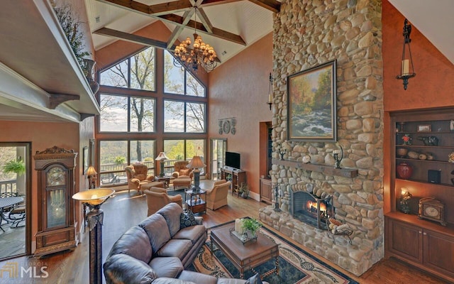 living room featuring hardwood / wood-style flooring, a stone fireplace, and high vaulted ceiling