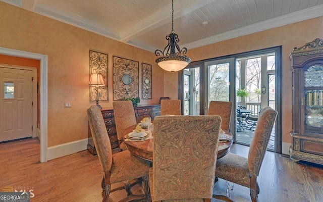 dining room featuring wood ceiling, wood-type flooring, ornamental molding, and beamed ceiling