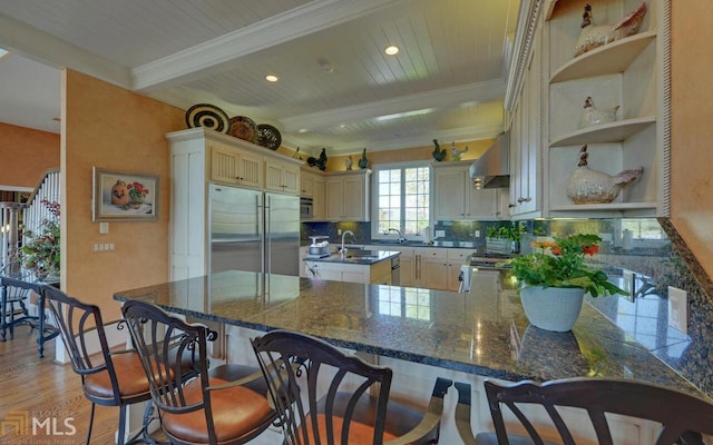 kitchen with light wood-type flooring, wooden ceiling, kitchen peninsula, stainless steel built in fridge, and beam ceiling