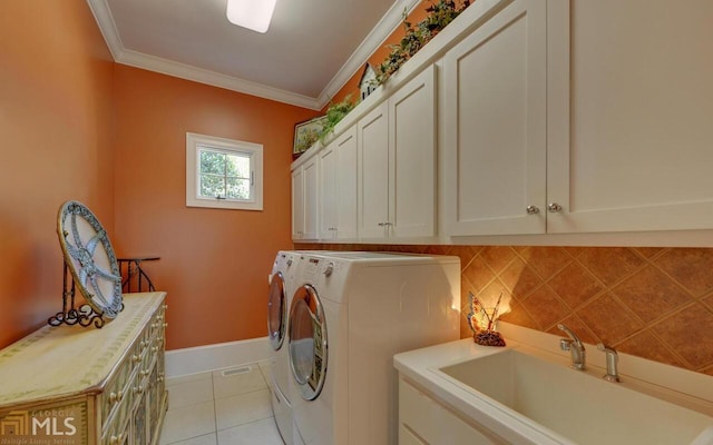 washroom featuring sink, cabinets, washer and dryer, light tile patterned floors, and ornamental molding