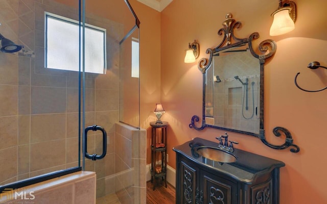 bathroom featuring vanity and a shower with door