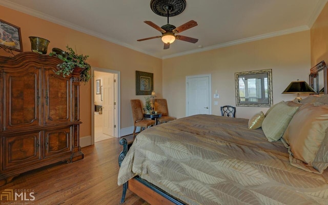 bedroom with crown molding, ceiling fan, ensuite bath, and light hardwood / wood-style flooring