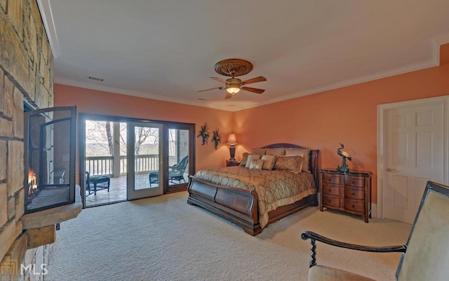 carpeted bedroom featuring crown molding, a large fireplace, access to outside, and ceiling fan