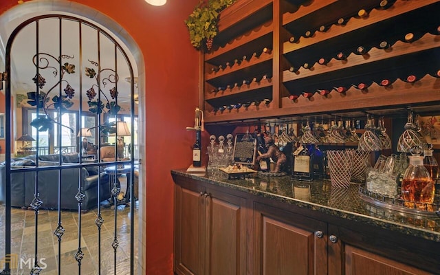 bar featuring dark stone countertops