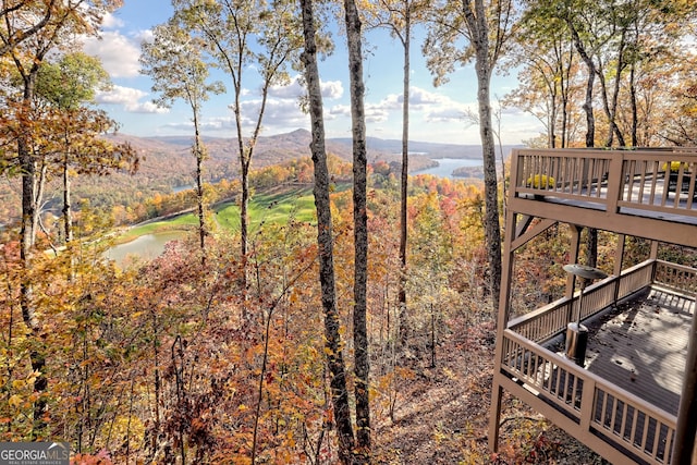 view of yard with a deck with water view