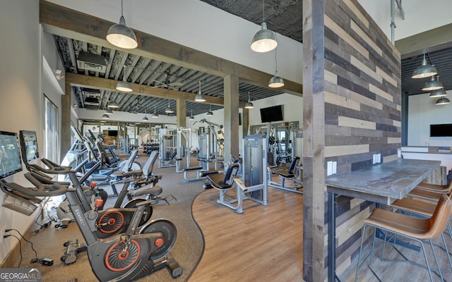 gym with hardwood / wood-style floors and a high ceiling