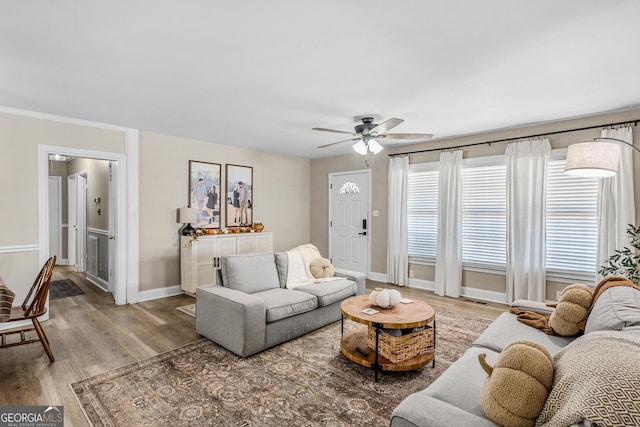 living room featuring hardwood / wood-style floors and ceiling fan