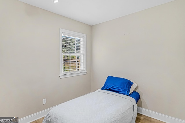 bedroom with wood-type flooring