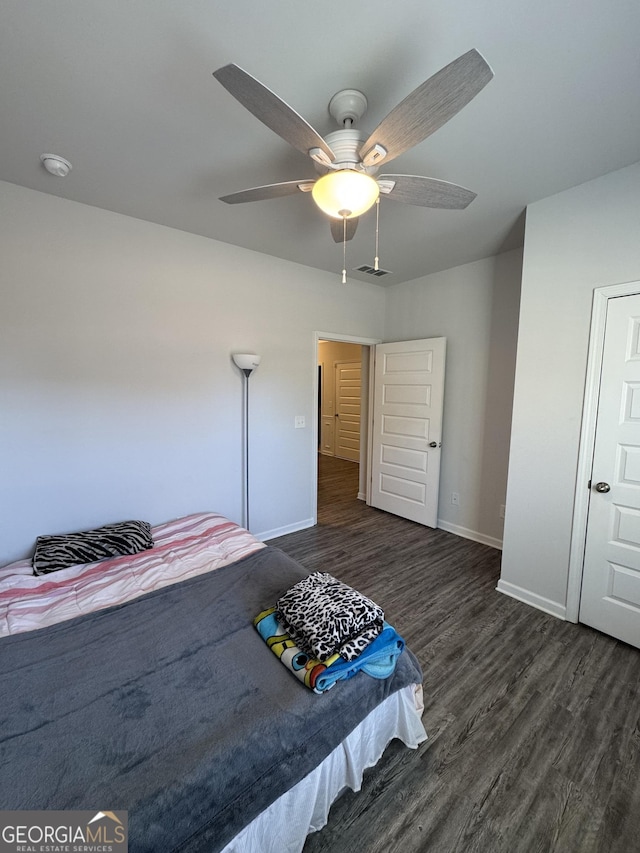 unfurnished bedroom featuring dark wood-type flooring and ceiling fan