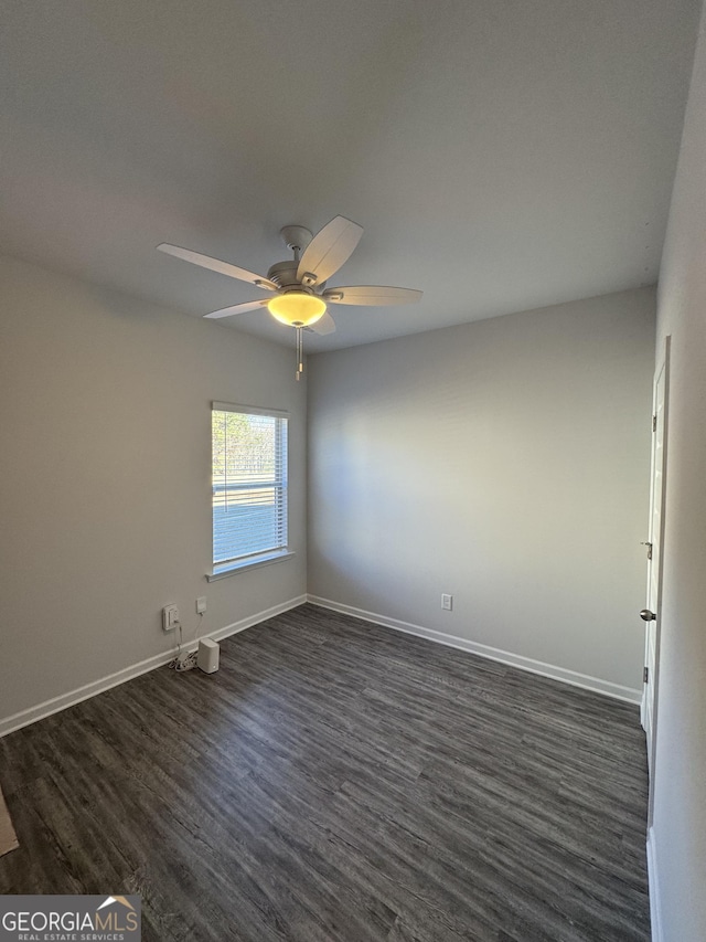 unfurnished room featuring ceiling fan and dark wood-type flooring