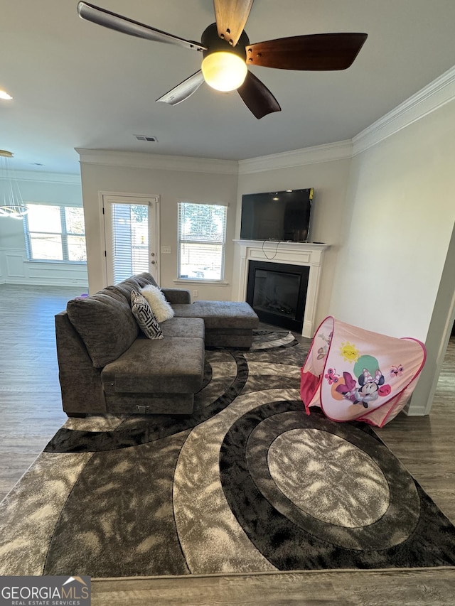 living room featuring ceiling fan, crown molding, and hardwood / wood-style floors