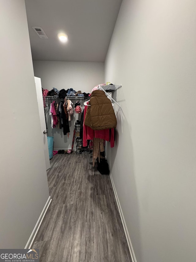 spacious closet featuring hardwood / wood-style flooring