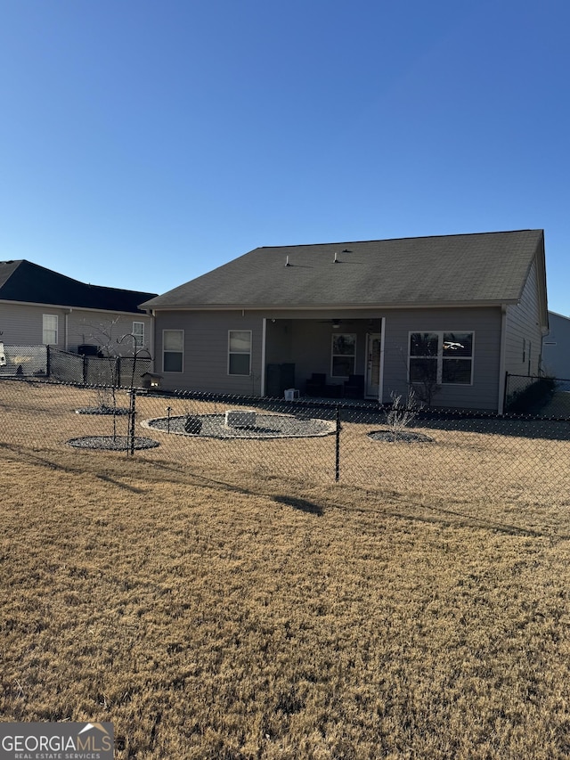 back of property featuring a lawn