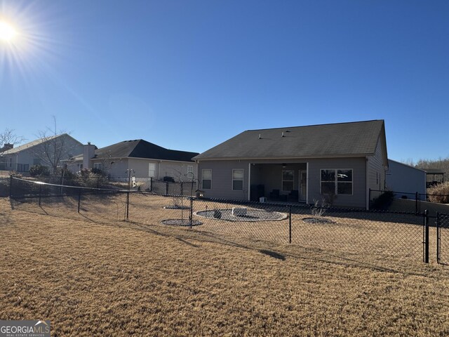 rear view of property with a yard