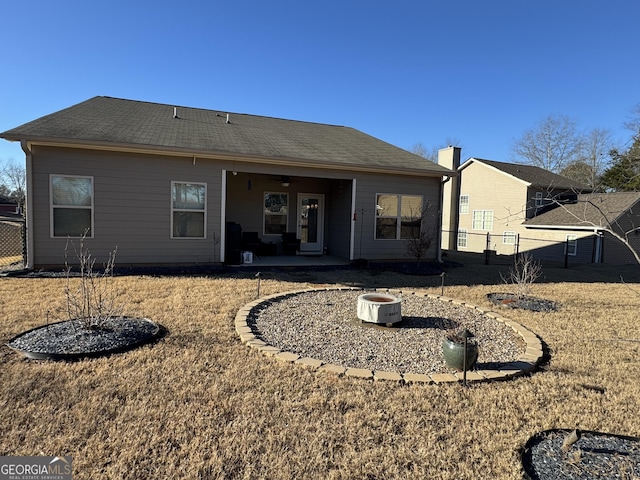 back of house featuring a patio area and a yard