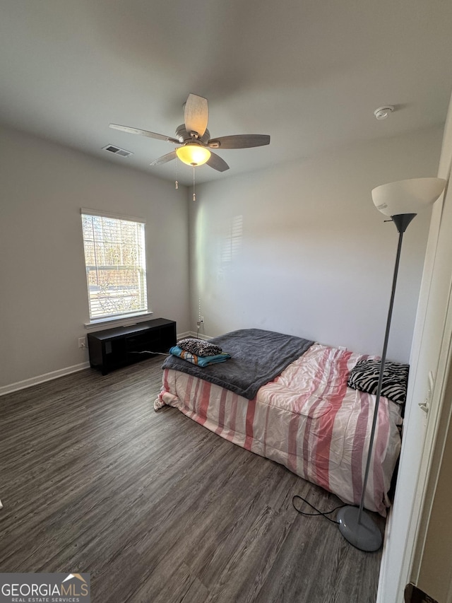 bedroom featuring ceiling fan and dark wood-type flooring