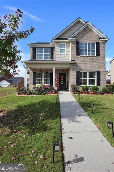 view of front of property with a front yard and covered porch