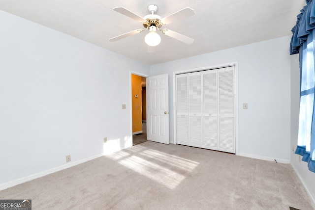 unfurnished bedroom with a closet, ceiling fan, and light colored carpet