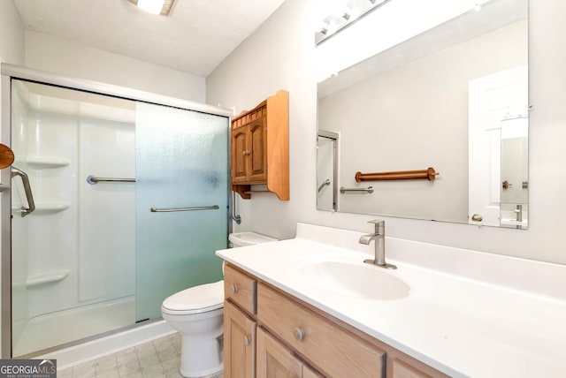 bathroom with toilet, walk in shower, a textured ceiling, and vanity