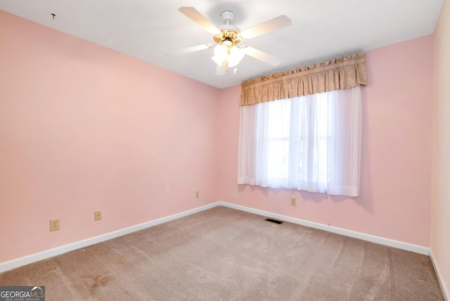 unfurnished room featuring light carpet and ceiling fan