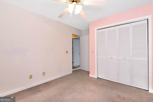 unfurnished bedroom featuring light colored carpet, ceiling fan, and a closet