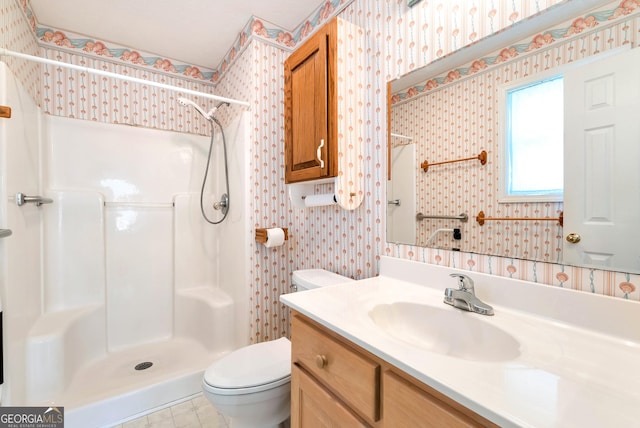 bathroom with toilet, a shower, and vanity